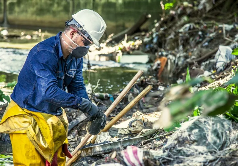 Worker cleaning up a construction site