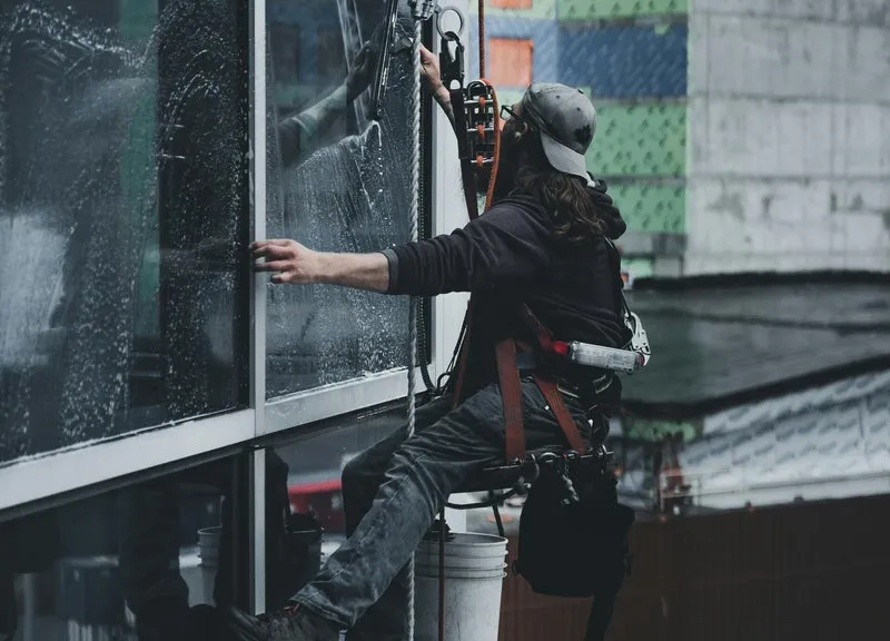 Professional cleaner working on a commercial window