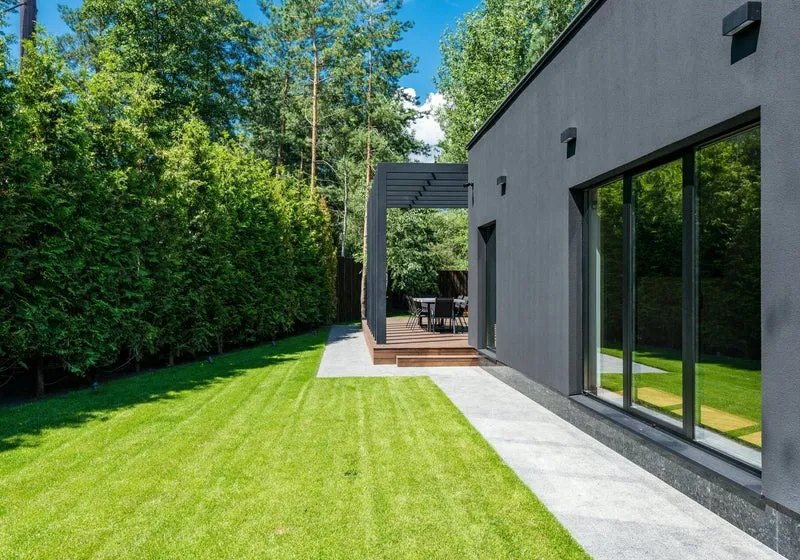 Modern home with landscaped patio and walkway