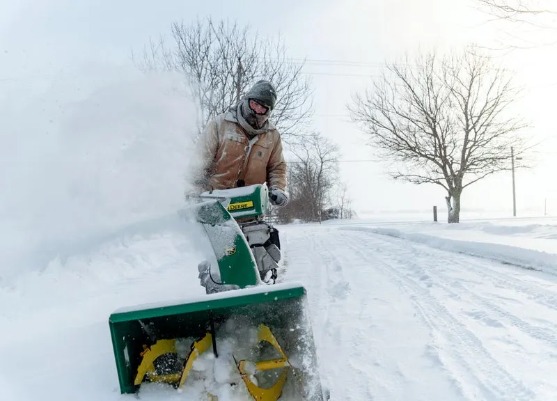 Snow blower clearing a residential drive