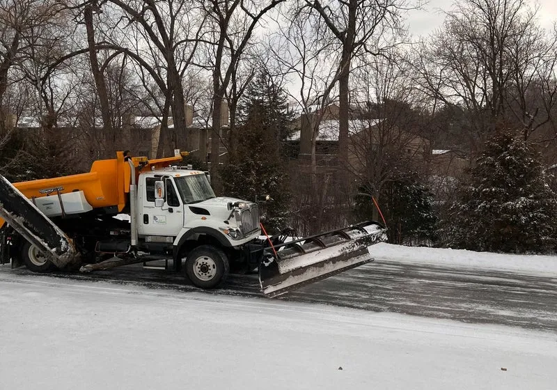 Snow plow clearing a driveway