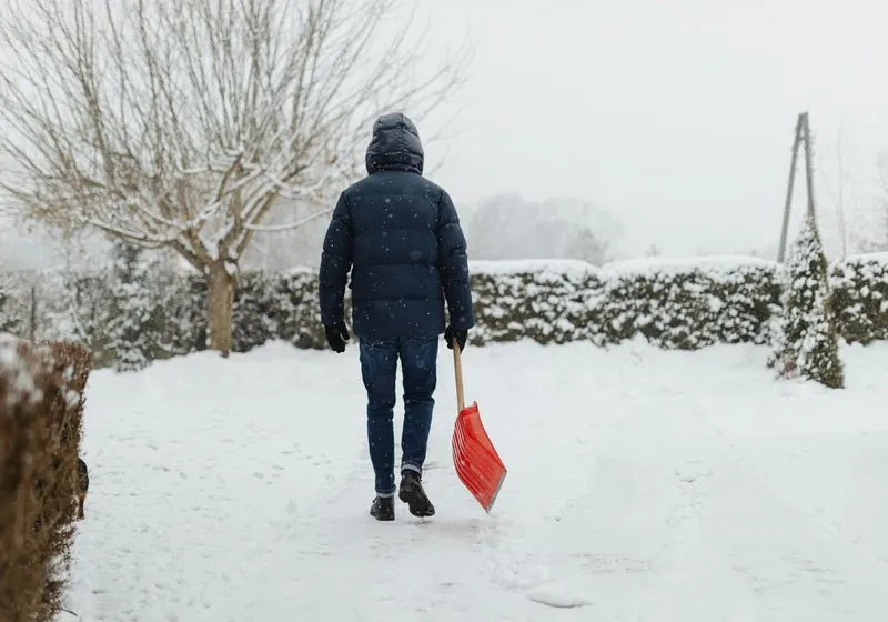 Person shoveling a snowy walkway